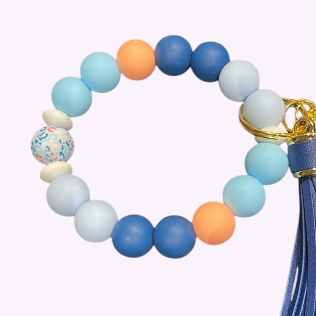 Wristlet met siliconen kralen in blauw en marble oranje met leren kwastje – stijlvolle pols sleutelhanger.