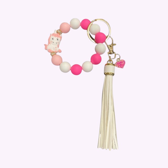 Armband met unicorn in wit met roze en een lederen kwast