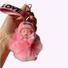 Roze fluffy sleutelhanger met slapend baby popje en LOVE-bandje – schattig accessoire voor tas of sleutelbos